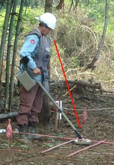 deminer looking beneath the bottom of his visor.